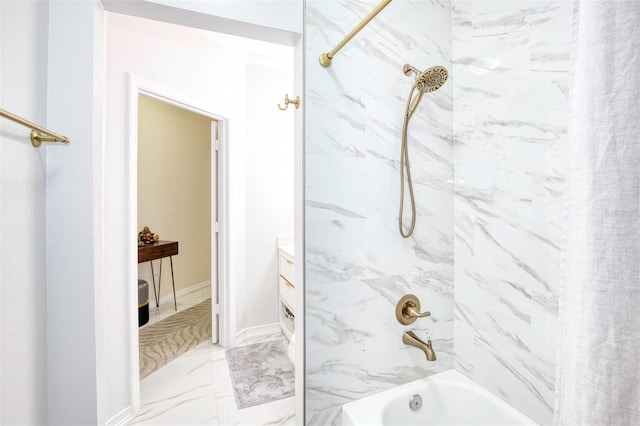 bathroom featuring tiled shower / bath combo and vanity