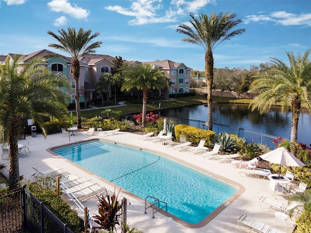 view of pool with a water view and a patio