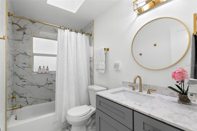 full bathroom with vanity, a skylight, shower / bath combo with shower curtain, and toilet