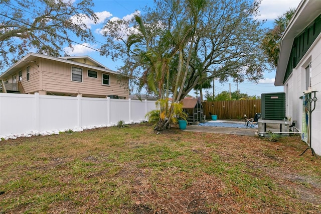 view of yard featuring central air condition unit and a patio area