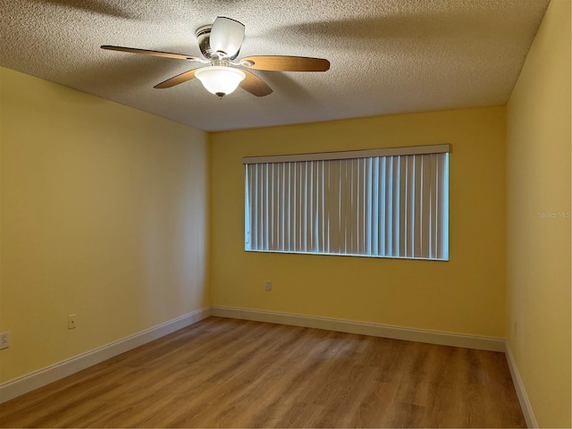 empty room with a textured ceiling, ceiling fan, and hardwood / wood-style flooring