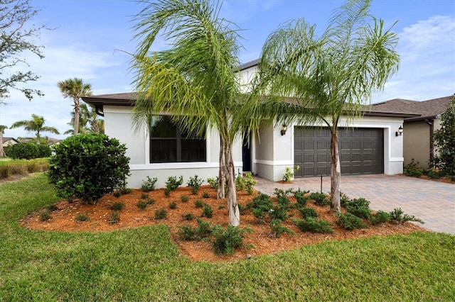 view of front facade with a garage and a front lawn