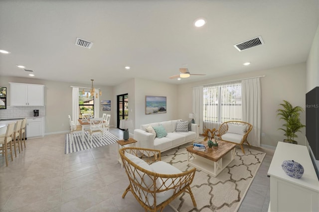 living room featuring ceiling fan and light tile patterned floors