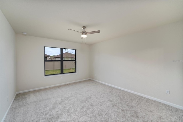 unfurnished room featuring ceiling fan and light colored carpet