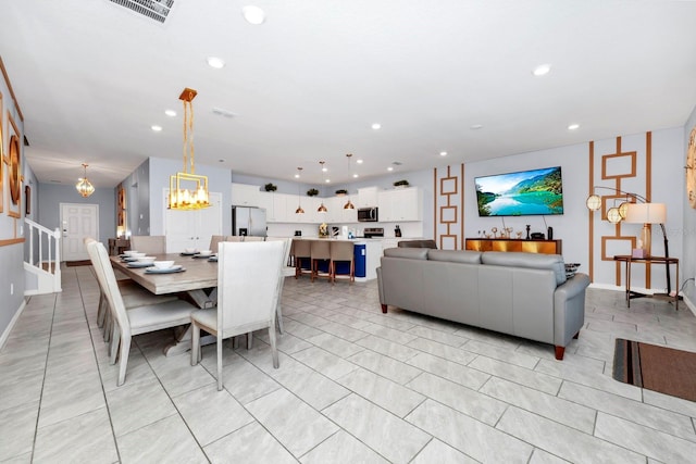 dining area with an inviting chandelier and light tile patterned floors