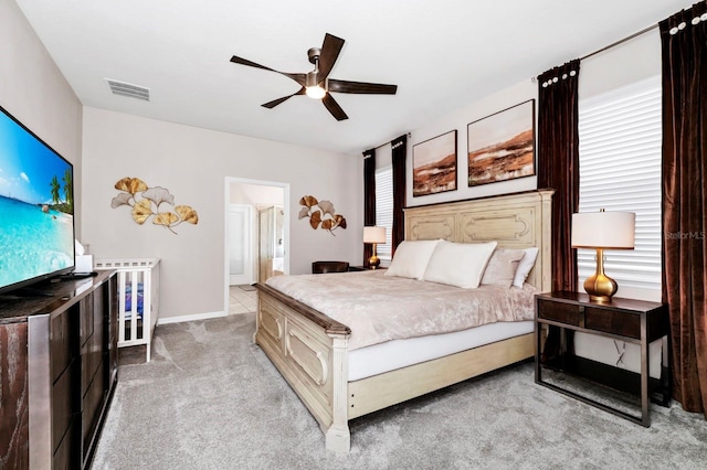 bedroom featuring light colored carpet and ceiling fan