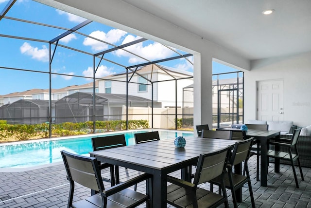 view of patio / terrace featuring a fenced in pool and glass enclosure