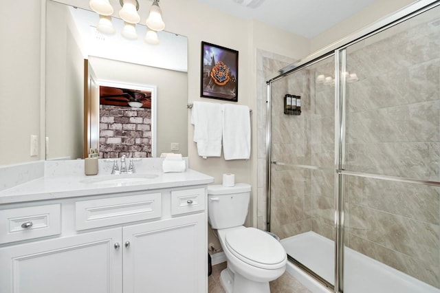 bathroom with vanity, toilet, and an enclosed shower