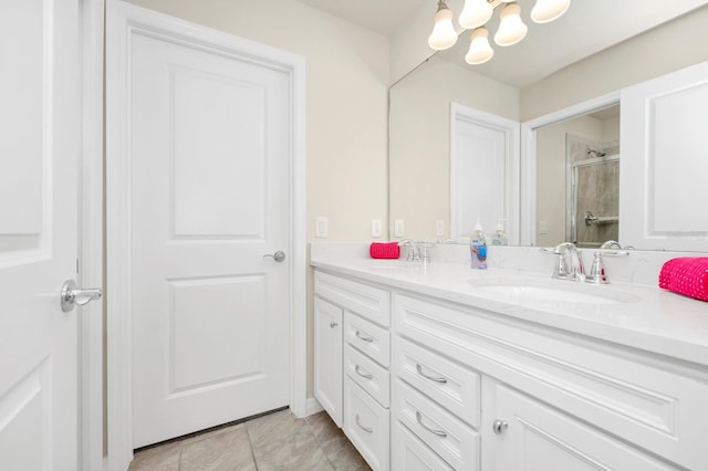 bathroom with vanity, an enclosed shower, and a chandelier