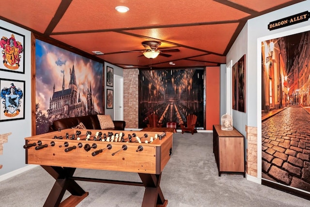 game room with ceiling fan, a textured ceiling, and carpet