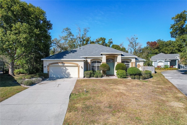 single story home with a garage and a front yard