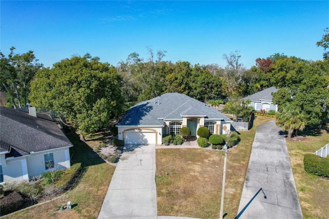 view of front of house with a front lawn and a garage