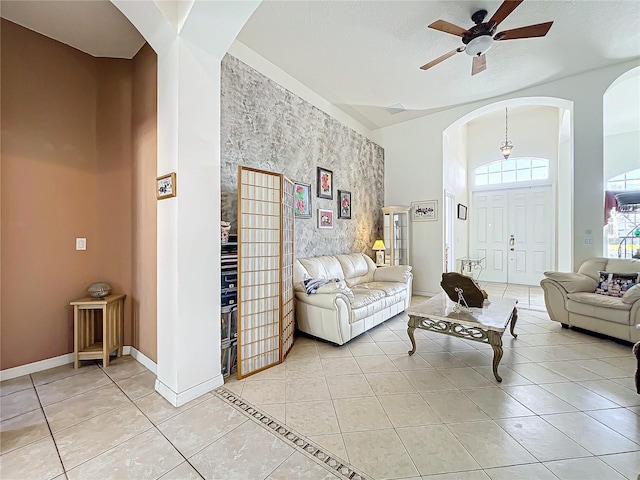 tiled living room featuring ceiling fan