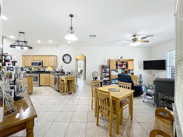 tiled dining area featuring ceiling fan