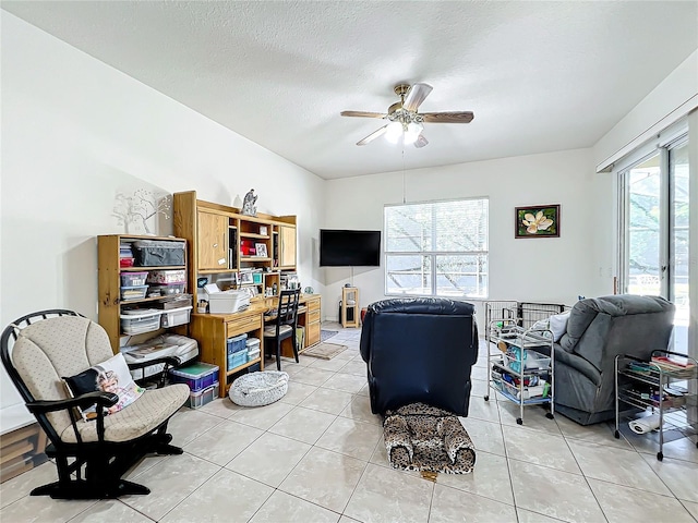 office featuring ceiling fan, a textured ceiling, and light tile patterned floors