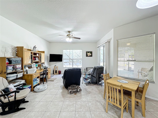 tiled living room featuring a textured ceiling and ceiling fan