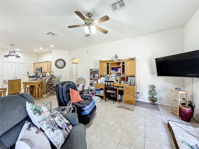 tiled living room featuring ceiling fan