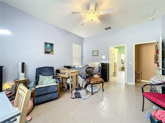 living area with ceiling fan and light tile patterned floors