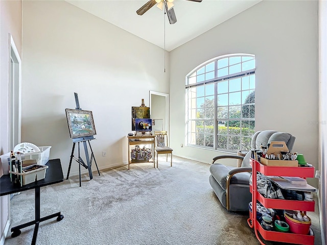 sitting room with vaulted ceiling, ceiling fan, and carpet floors