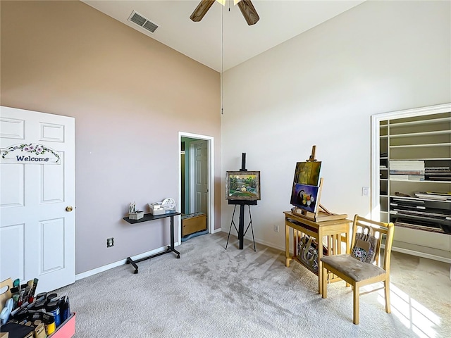 misc room featuring light carpet, ceiling fan, and high vaulted ceiling