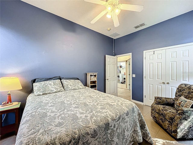 tiled bedroom with ceiling fan and a closet