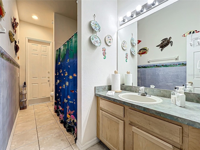 bathroom with tile patterned floors, vanity, and toilet