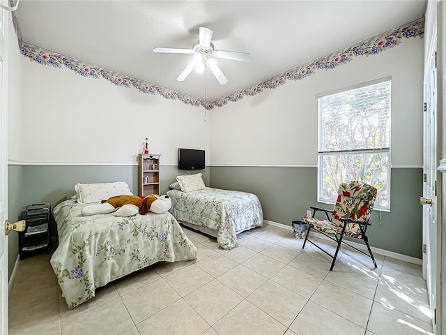 bedroom with ceiling fan and light tile patterned floors