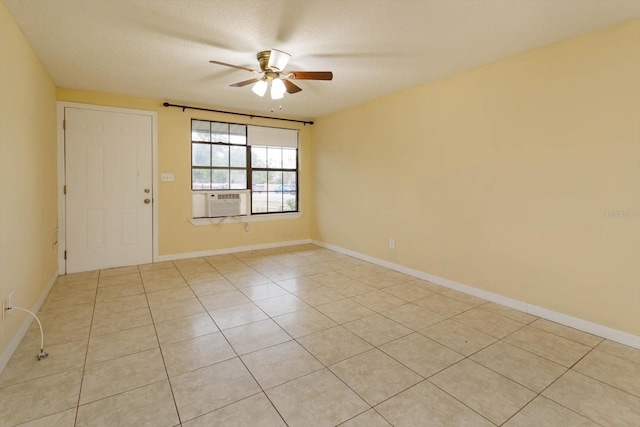 unfurnished room featuring a textured ceiling, ceiling fan, light tile patterned floors, and cooling unit