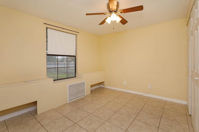 unfurnished room with ceiling fan and light tile patterned floors