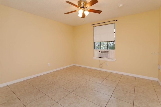 empty room with ceiling fan, light tile patterned floors, and cooling unit