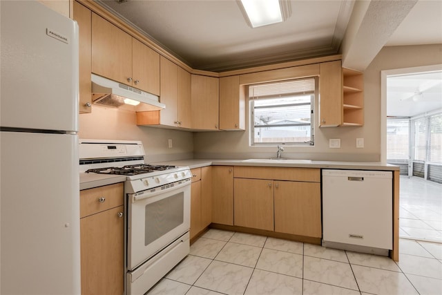 kitchen with sink, a wealth of natural light, light brown cabinetry, and white appliances