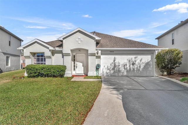 view of front of property featuring a front yard and a garage