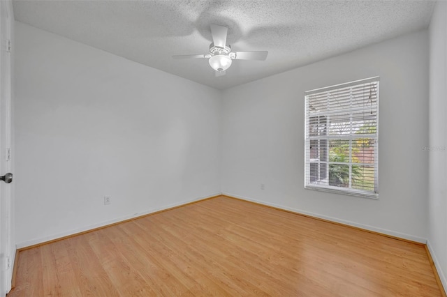 unfurnished room with ceiling fan, a textured ceiling, and light hardwood / wood-style flooring