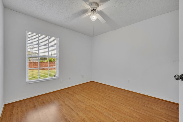 spare room with ceiling fan, a textured ceiling, and light hardwood / wood-style flooring