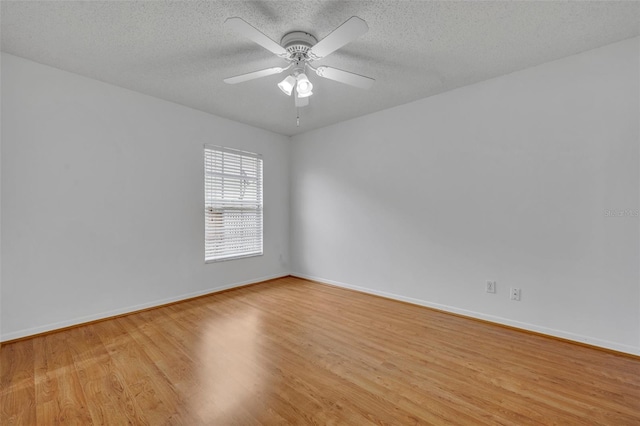 empty room with ceiling fan, a textured ceiling, and light hardwood / wood-style flooring