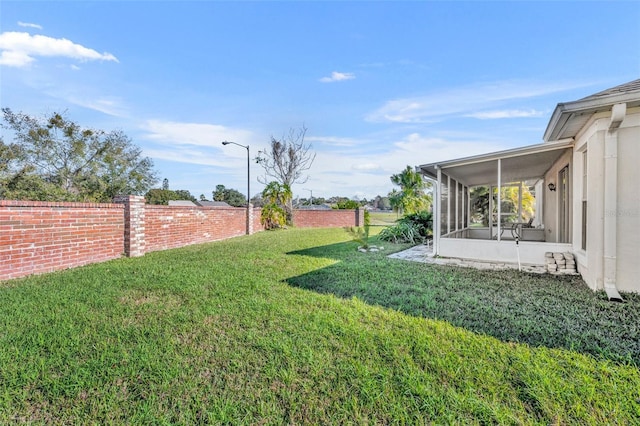 view of yard with a sunroom