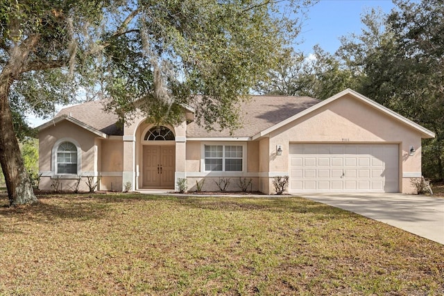 ranch-style house with a garage and a front yard