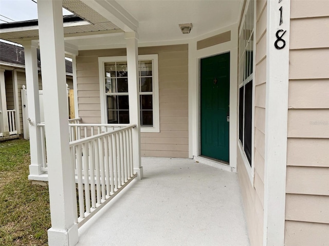 view of exterior entry with covered porch