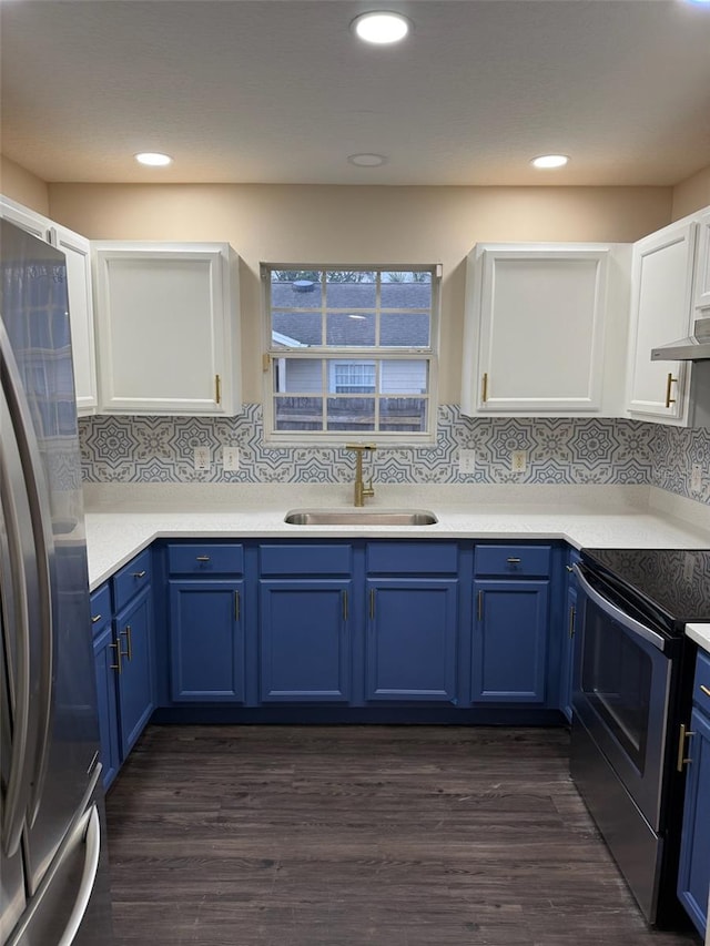 kitchen with decorative backsplash, appliances with stainless steel finishes, sink, and blue cabinetry