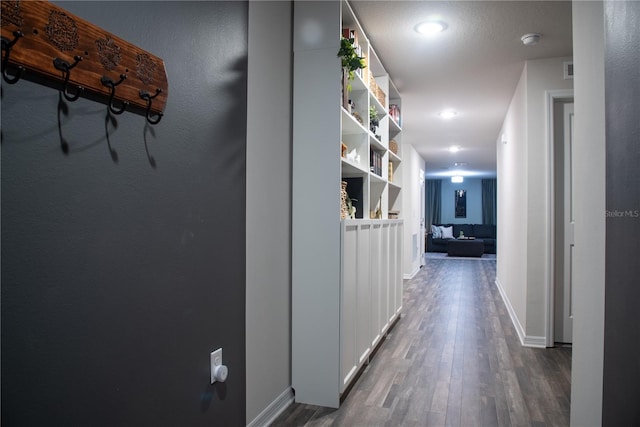 hallway with hardwood / wood-style flooring