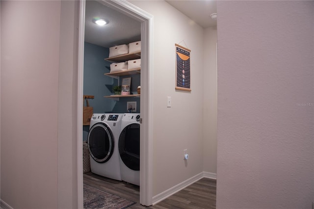 laundry area featuring washing machine and dryer and dark wood-type flooring