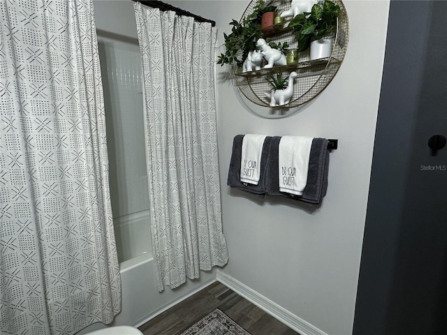 bathroom featuring hardwood / wood-style floors and shower / tub combo with curtain