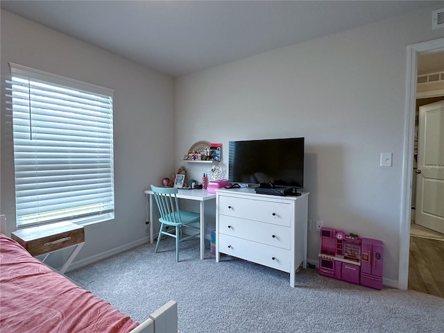 carpeted bedroom with multiple windows