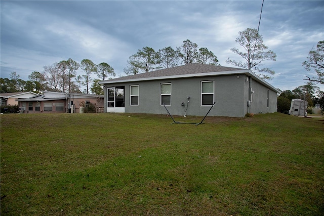 rear view of house with a yard