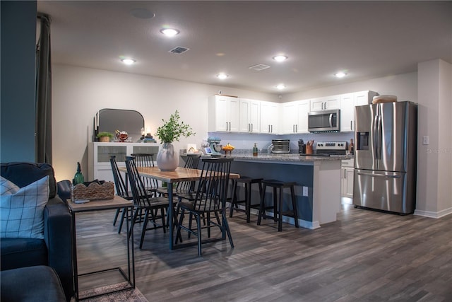 dining area with dark wood-type flooring