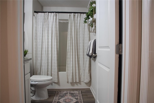 full bathroom featuring hardwood / wood-style flooring, toilet, vanity, and shower / tub combo with curtain