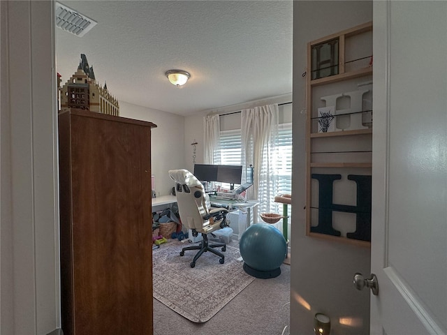 office area featuring a textured ceiling and carpet flooring