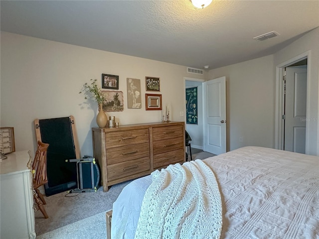 carpeted bedroom featuring a textured ceiling