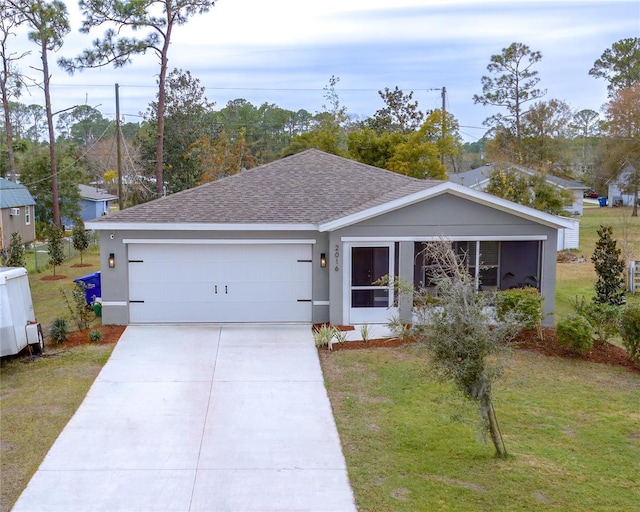 ranch-style house featuring a garage, driveway, roof with shingles, stucco siding, and a front yard