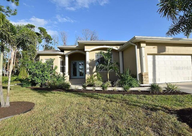 view of front facade with a front yard and a garage